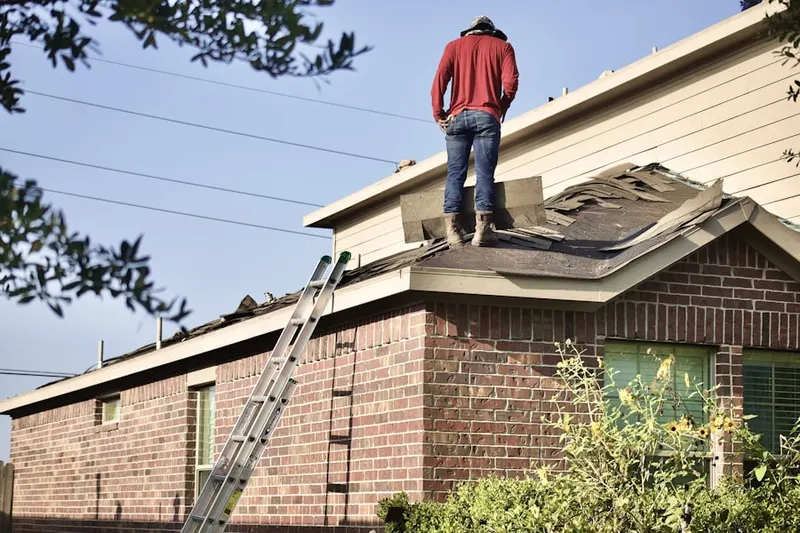 Professional roofer working on a residential roof in White Meadow Lake